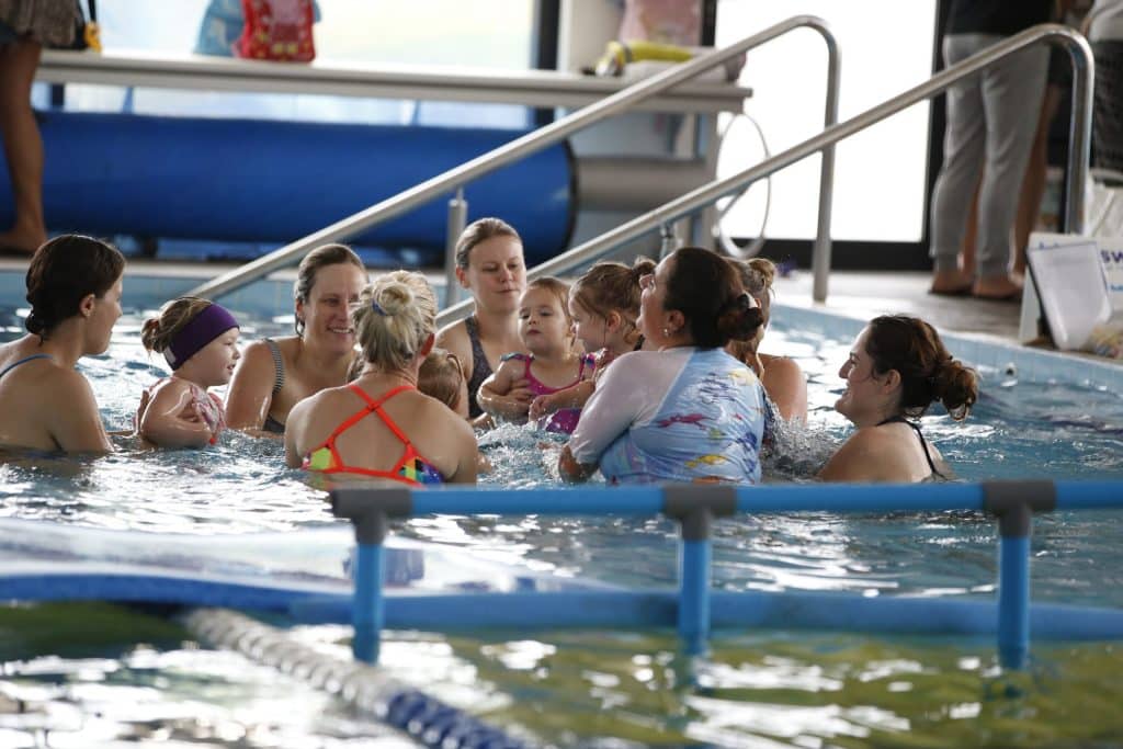 Swimming Classes For Babies In Action With Many Parents In The Watch With Their Children
