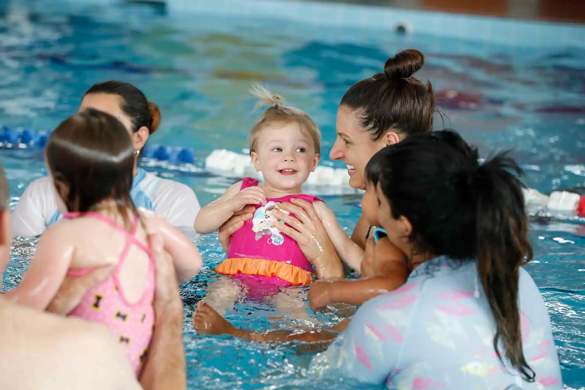 Baby Swim Lessons Happening In A Pool With Mother And Baby Daughter Present